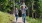 a group of people walking on a path in the woods