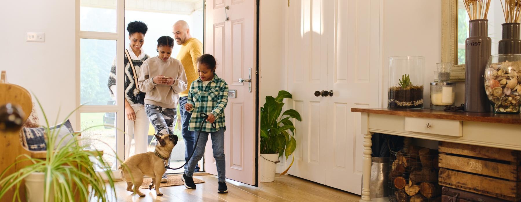 a group of people standing in a room with a dog